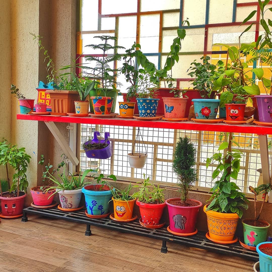 Playful Balcony Garden with Hand-Painted Pots